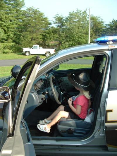 Little girl sitting in driver's seat