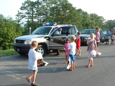 Kids walking near Police Cruisers